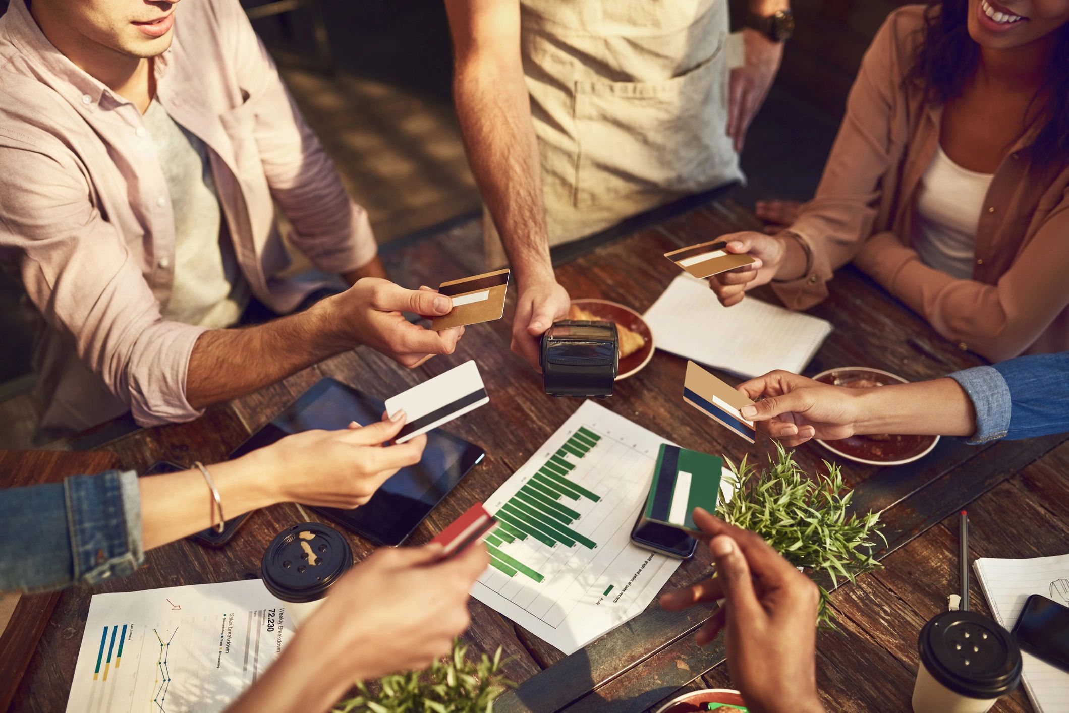Business colleagues handling payment cards together